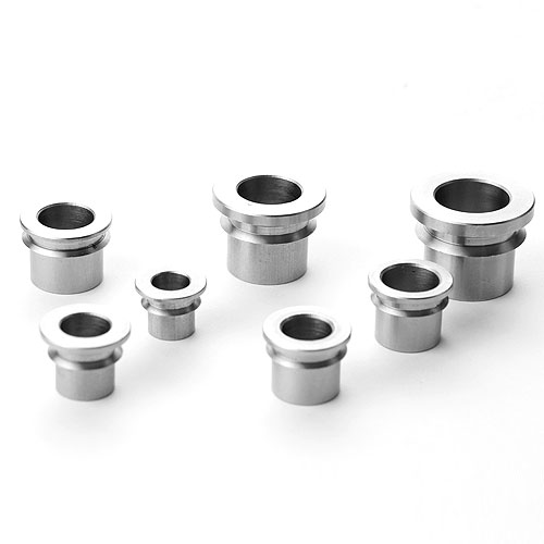 Steel heim joint misalignment spacers with turned spherical seat and bore
